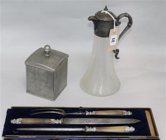 A three piece carving set, claret jug and caddy H 27.5cms